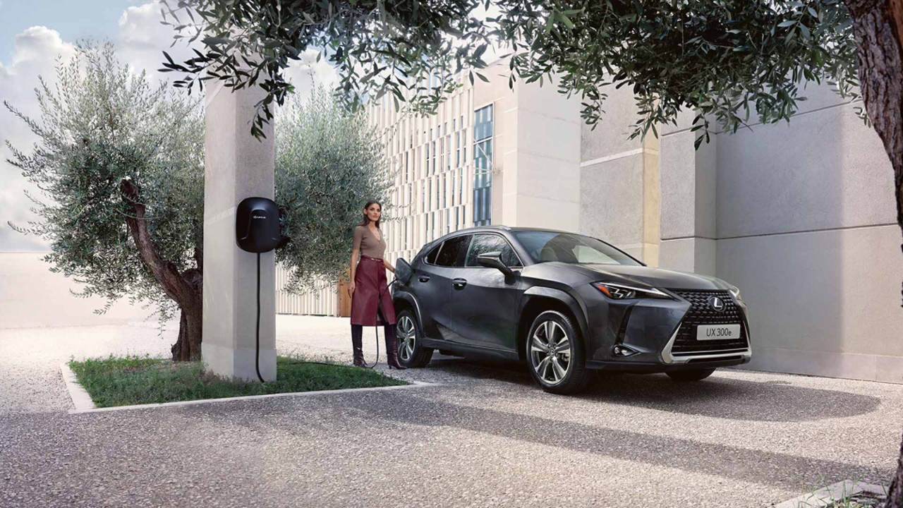 A person plugging in a charging socket into a Lexus UX 300e