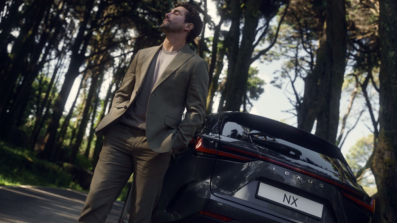 A man standing beside a Lexus NX