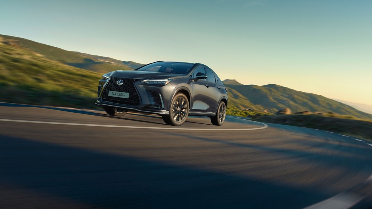 A Lexus NX driving on a hillside road